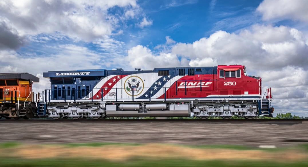 BNSF 250 in red, white and blue America 250 livery with the Great Seal, shown broadside at speed